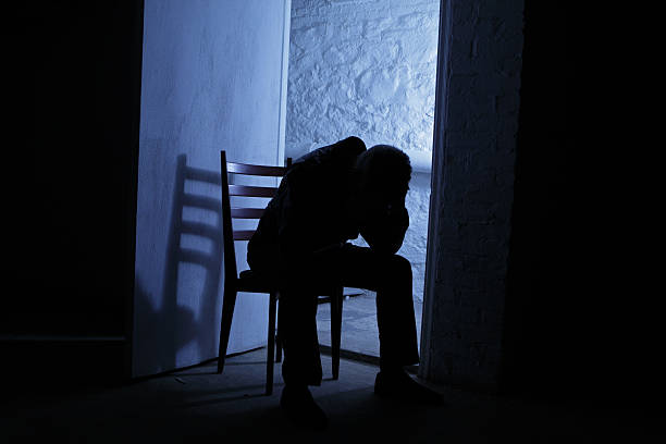 istock Depressed male in blue night shadows 475898563