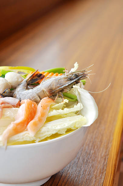 Hot pot of Thai style with shrimp and salmon