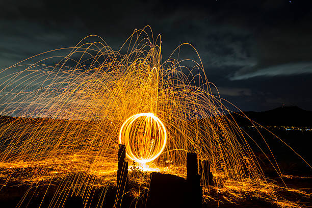 istock Firework showers of hot glowing sparks from spinning steel wool. 475913330