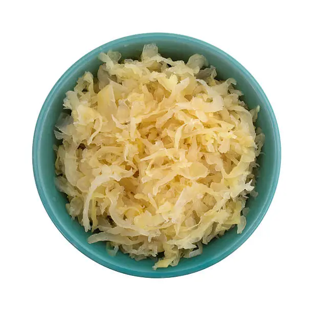 Top view of a small bowl filled with canned sauerkraut isolated on a white background.