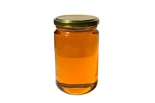 istock Glass jar of honey with clipping path 475915200