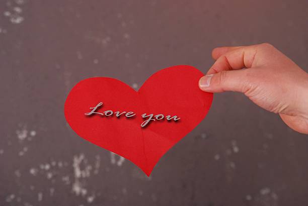 istock Man hand hold love you card 475916962