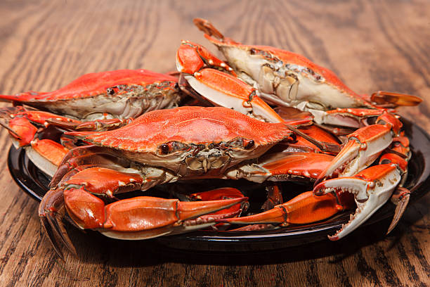 istock Heap of steamed Blue Crabs on a wooden table 475917699