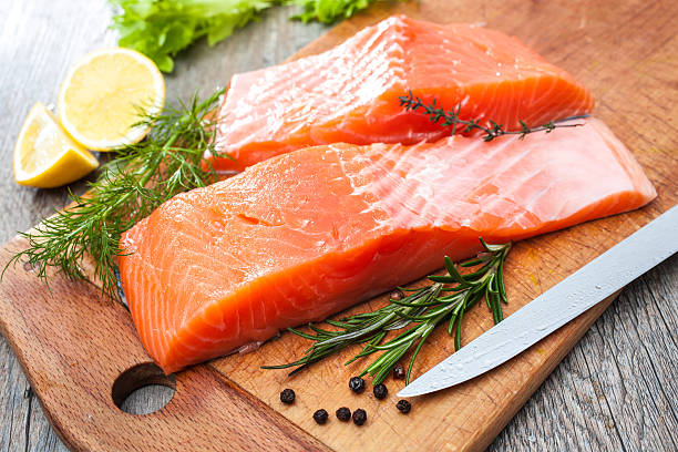 istock Raw salmon fish fillet with fresh herbs 475918275