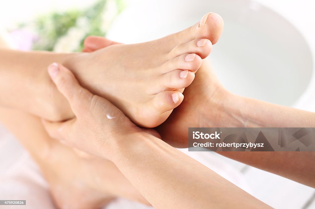 Foot massage, Woman in a beauty salon for pedicure and foot massage. Pedicure Stock Photo