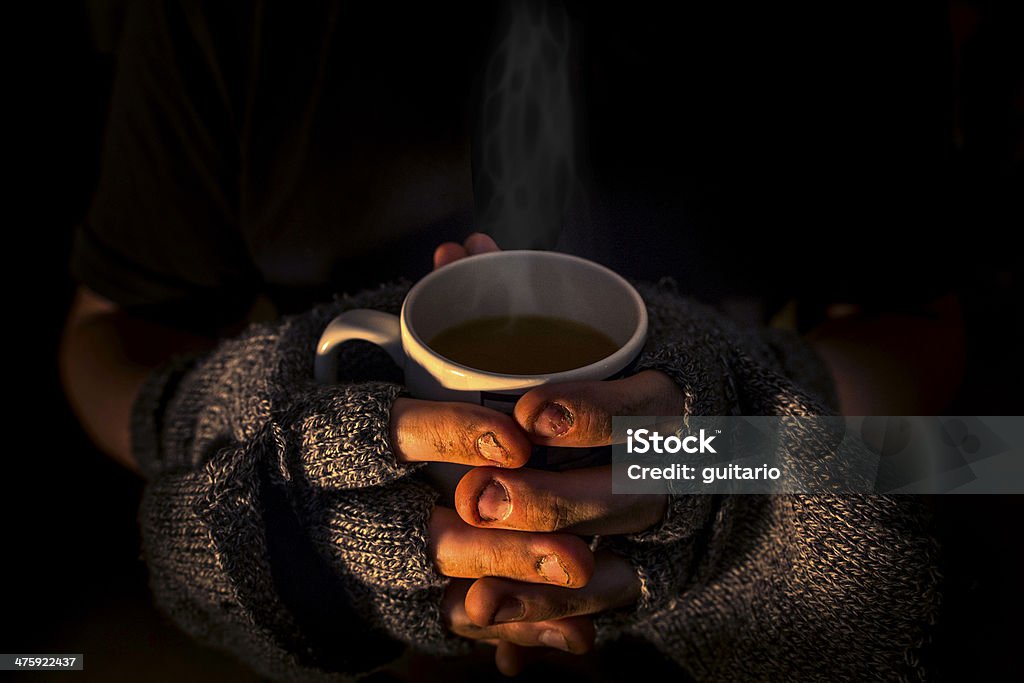 Homeless and humble Homeless man with a hot steaming cup of tea Homelessness Stock Photo