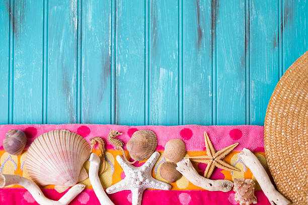 istock Summer vacation scene. Seashells on beach towel. Blue background. 475923844