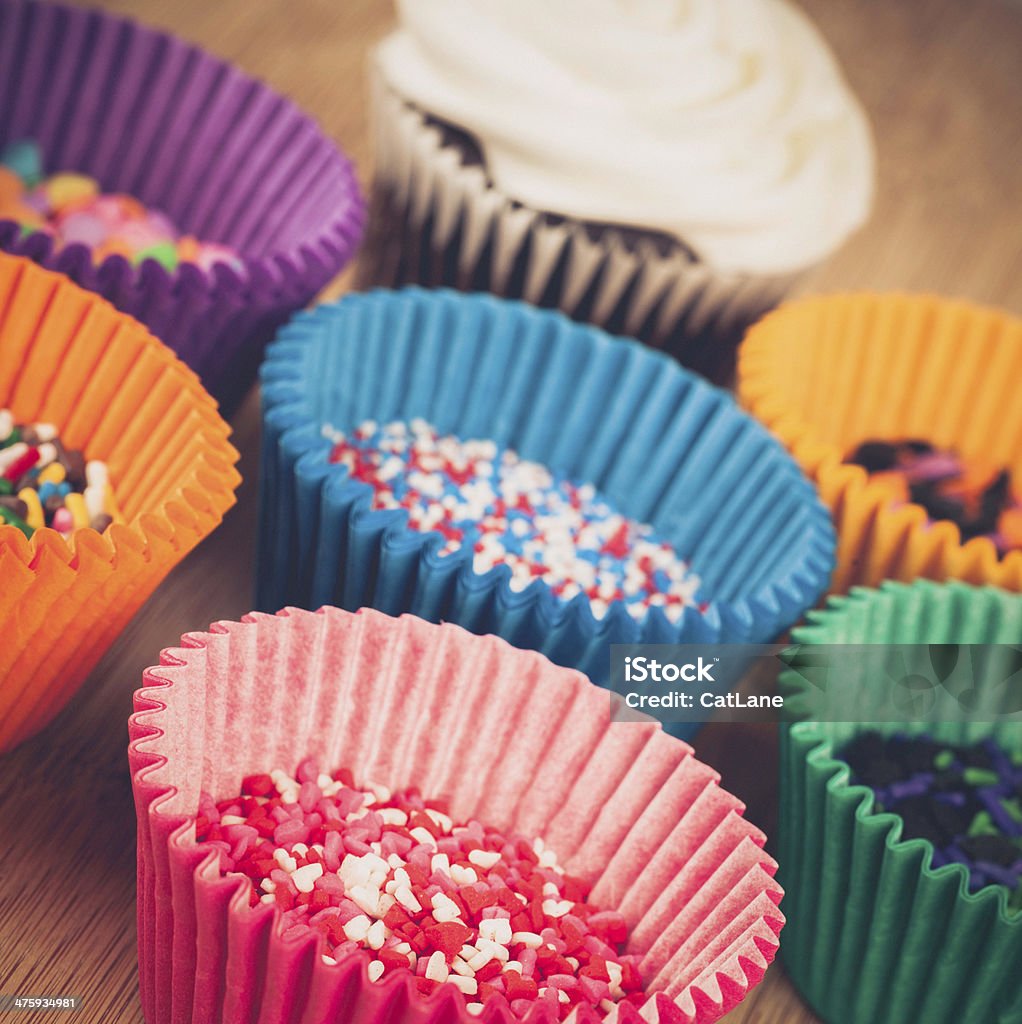 Cake Baking Supplies: Cupcake Liners, Sprinkles and Cupcake Cake Stock Photo
