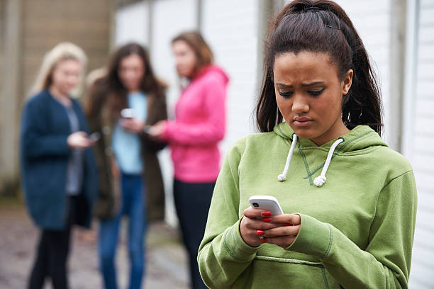 Teenage Girl Being Bullied By Text Message Area of concern for parents of young people online bullying stock pictures, royalty-free photos & images