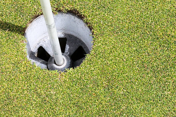 istock Close up of a golf hole with flag base 475947422