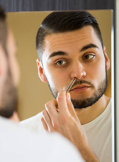istock Handsome man remove hair with pincers 475951568