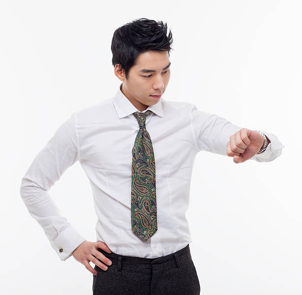 istock Young business man consulting his watch 475955899