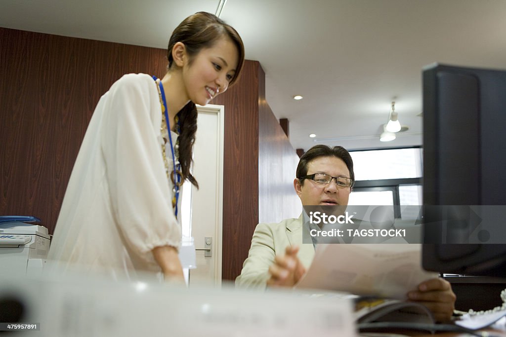 Boss and staffs looking over documents 20-29 Years Stock Photo