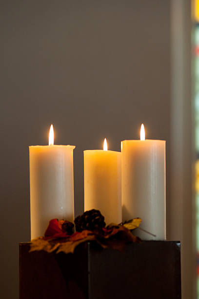 Three burning candles at funeral service #JWK5742 stock photo