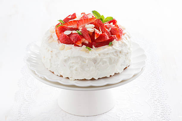istock cake with whipped cream and strawberries on a stand 475959344