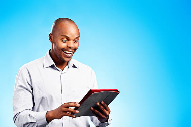 istock Look what this can do! Overjoyed man discovers digital tablet 475961959