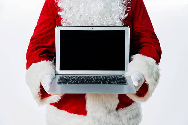istock Santa claus showing laptop 475963590