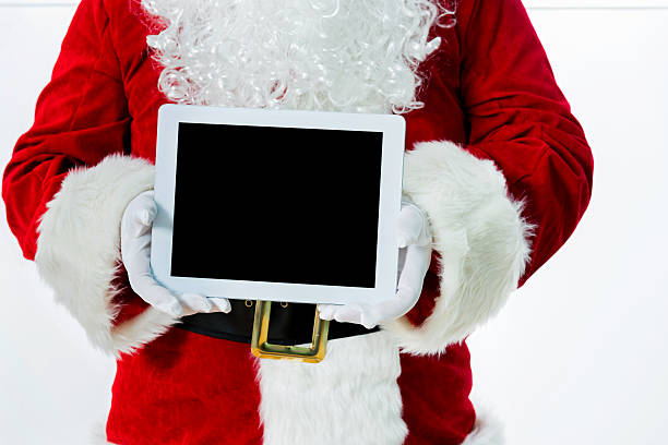istock Santa claus showing digital tablet 475963644