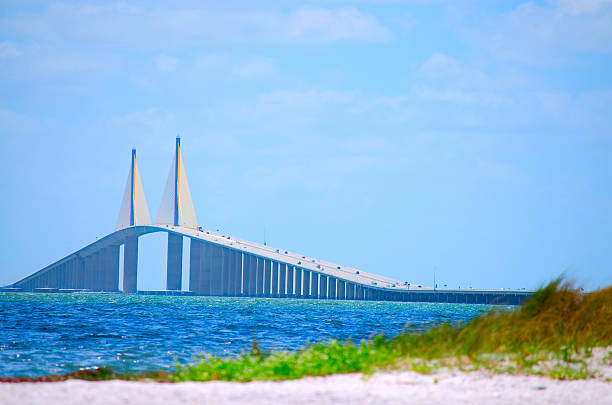 Sunshine Skyway Bridge with beach Tampa Bay Florida USA Sunshine Skyway Bridge crossing Tampa Bay in Florida with a beach in the foreground. elevated walkway photos stock pictures, royalty-free photos & images