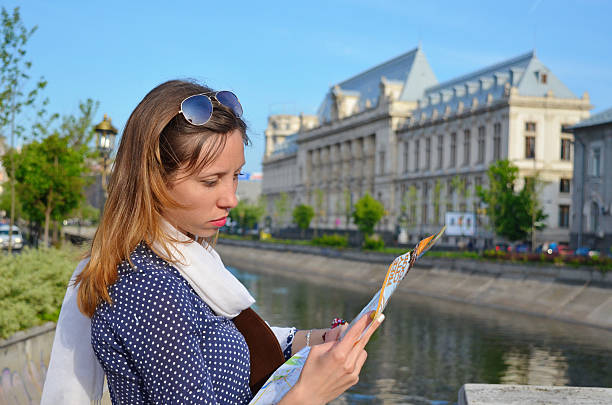istock Young girl reading a map close to a river 475963982