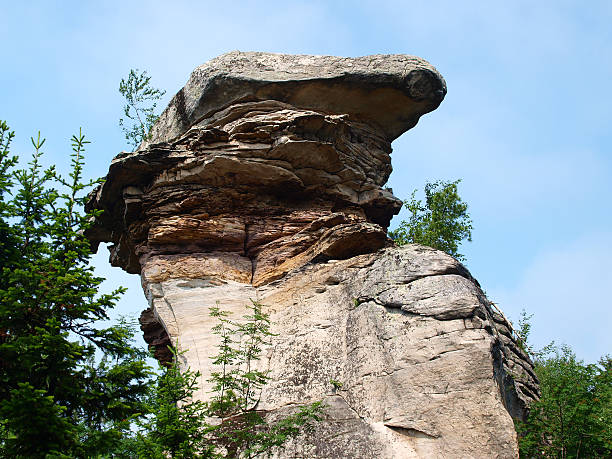 istock Oddly shaped rock on a background of blue sky 475965880