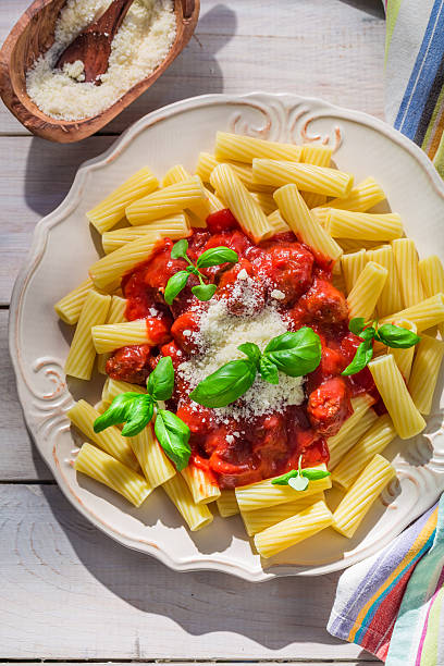 istock Homemade pasta penne with tomato sauce and basil 475966438