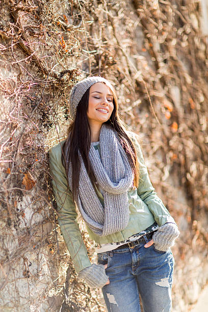 istock Young woman by the wall 475967274
