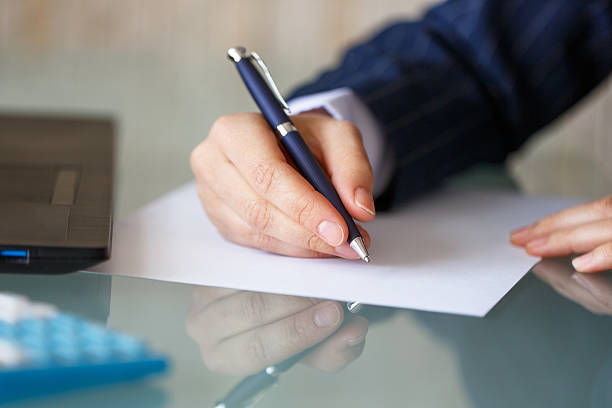 istock Businesswoman hand write on blank paper 475967426