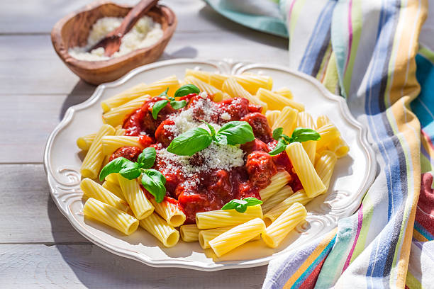 Delicious pasta penne with tomato sauce and parmesan Delicious pasta penne with tomato sauce and parmesan. penne meatballs stock pictures, royalty-free photos & images