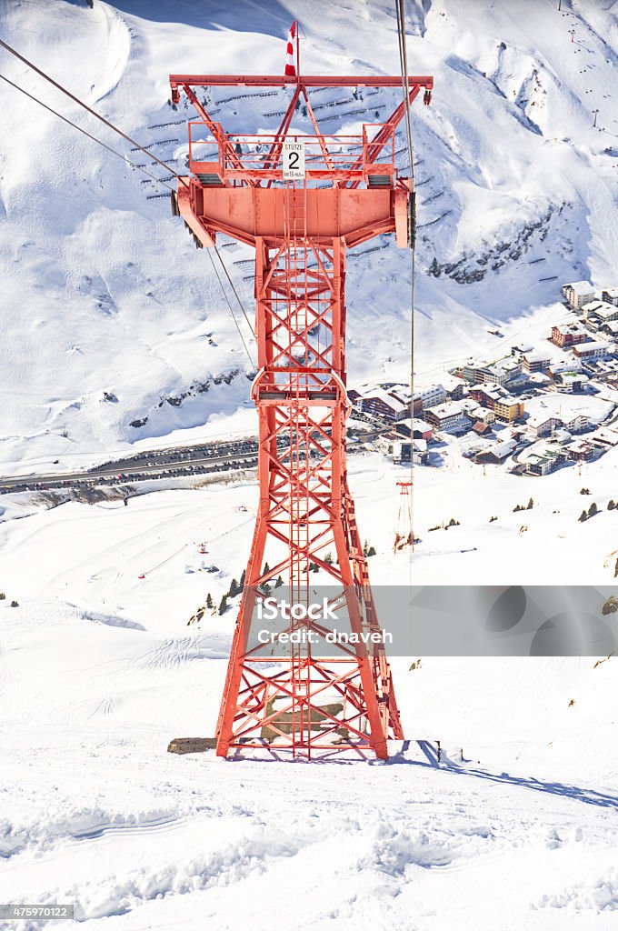 Ski gondola pylon in Lech - Zurs resort, Austria Ski gondola - cable car pylon - pole and a bird's eye view of the hamlet of Zurs and the Lech - Zurs ski resort in Arlberg, Tyrol, Austria 2015 Stock Photo