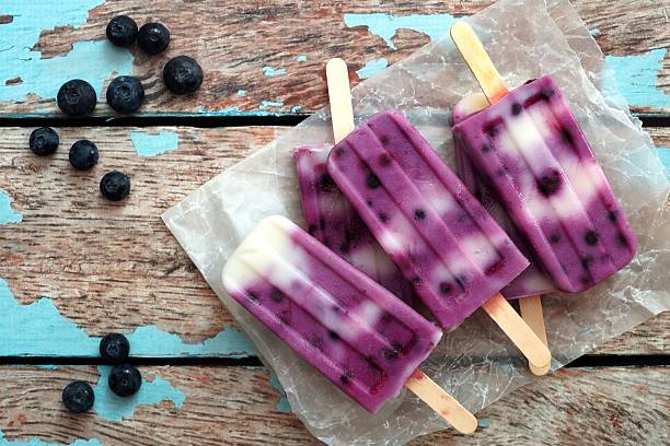 istock Homemade blueberry vanilla ice pops in a cluster on paper 475970218