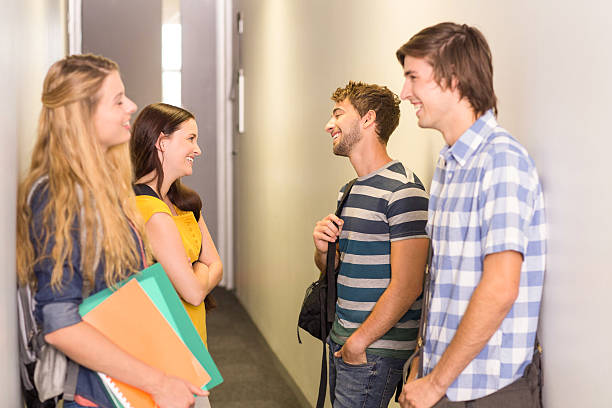 istock Students with files standing at college corridor 475970750