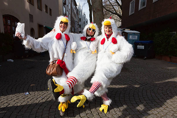 carnival weiberfastnacht celebration women dancing in chicken costumes - tavuk kostümü stok fotoğraflar ve resimler