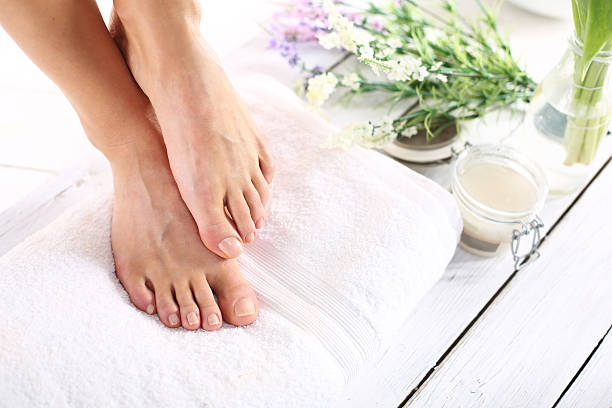 Women's feet Beautiful feet of a woman during treatments. feet on feet stock pictures, royalty-free photos & images