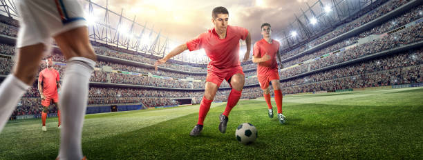 istock Soccer player kicking ball in stadium 475975432