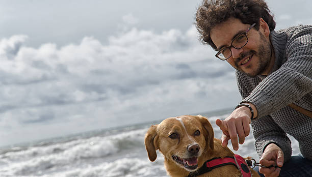 istock Man and dog on the beach 475975730