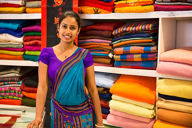Sri Lankan woman in a Sari as a shop assistant Sri Lankan woman in a Sari working as a shop assistant sri lankan culture stock pictures, royalty-free photos & images