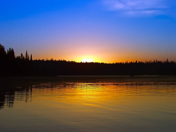 istock Sunrise over the lake and forest 475976840
