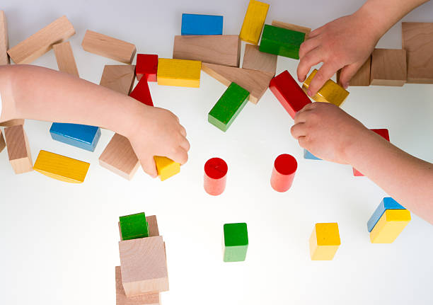 istock Child's hand and building blocks 475979120