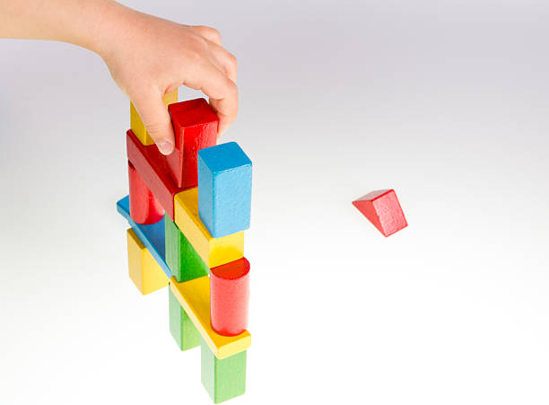 istock Child's hand and building blocks 475979136