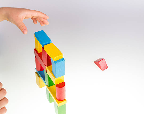 istock Child's hand and building blocks 475979138