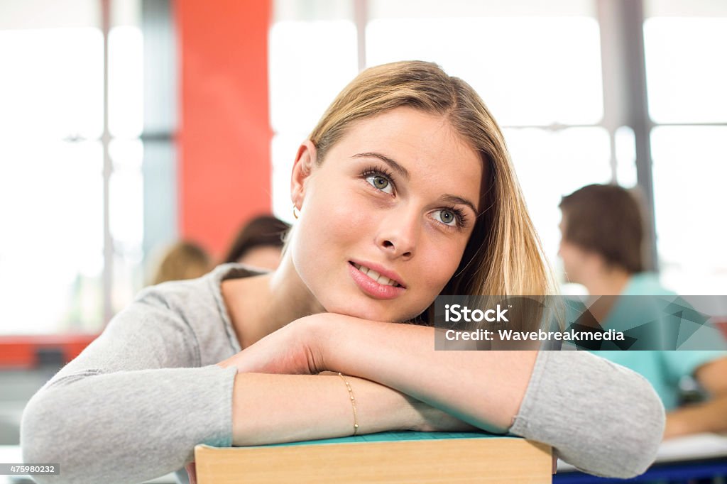 Thoughtful student with books in classroom Thoughtful female student with books in the classroom Beauty Stock Photo