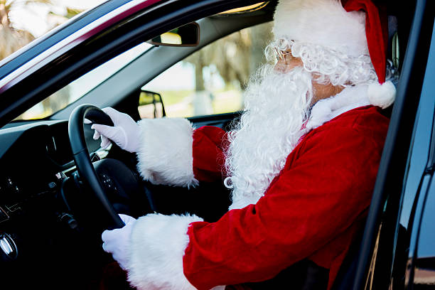 istock Santa claus driving a car 475980498
