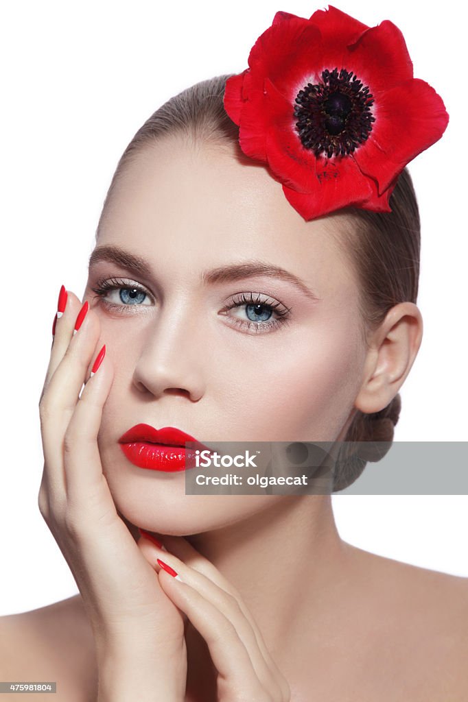 Organic beauty Young beautiful woman with clean make-up, red lips, fancy manicure and red flower in her hand over white background 2015 Stock Photo