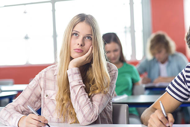 istock Thoughtful female student in classroom 475981860