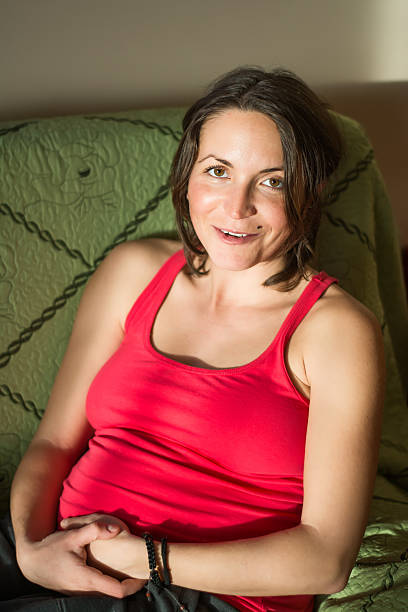 istock young pregnant woman posing on the couch 475982377