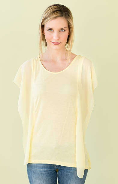 istock Woman Standing With Hands Behind Back Against Green Background 475982623