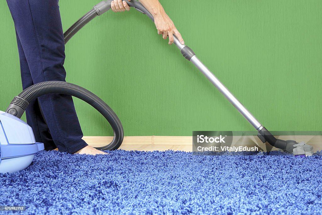 Vacuum cleaner in action Powelful vacuum cleaner in action-a men cleaner a carpet. Activity Stock Photo