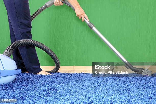 Vacuum Cleaner In Action Stock Photo - Download Image Now - Activity, Adult, Blue
