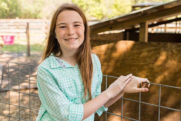 istock Farm Girl with a Goat 475984073
